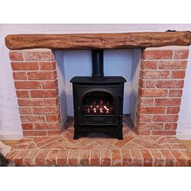 Gas stove coal effect. Brick fireplace and an oak beam. 