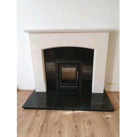 Stovax riva 40 cassette 5kw stove. Black polished granite hearth and back panel. Portuguese limestone mantel. 