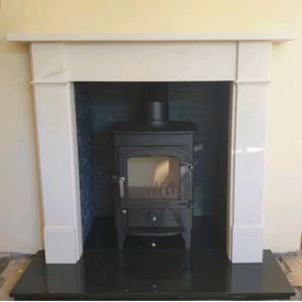 Clearview Pioneer 400 5kw multifuel stove. Aegean limestone Hersham mantel. Riven slate chamber set. Black polished granite hearth