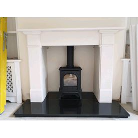 Gazco huntingdon 20 with clear door gas stove. Aegean limestone mantel. Black polished granite hearth 