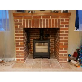 Brick fireplace with oak shelf. Heta Ambition 5 woodburner 5kw.