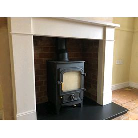 Clearview Pioneer 400 5kw stove. Hersham mantel in Aegean limestone. Slate hearth. We rebuilt the brickwork inside. 