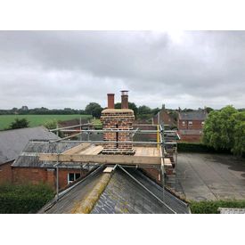 Repointed chimney stack with lime mortar and cowls fitted. 